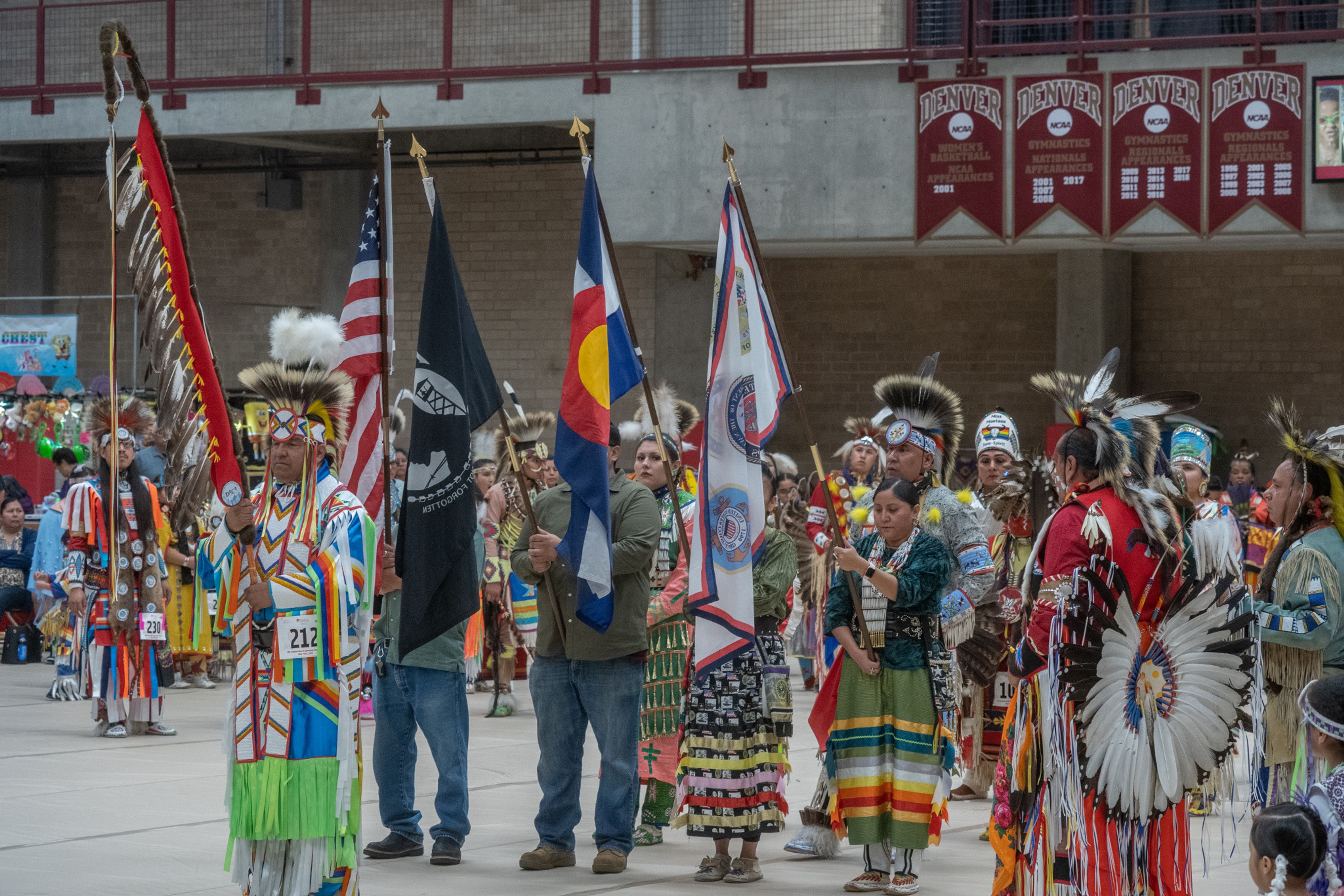 people at Native American Heritage Months standing with flags